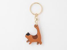 a wooden keychain shaped like a dog