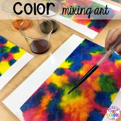 someone is making art with colored paper and watercolors