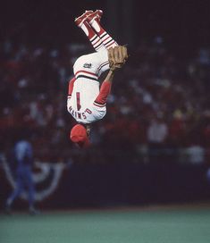 a professional baseball player in mid air during a game