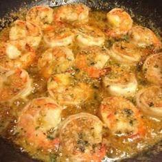 some shrimp and other food cooking in a skillet