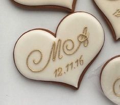 three decorated heart cookies with names and date