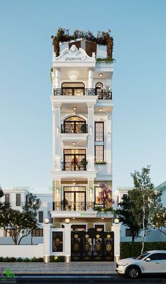 a white car parked in front of a tall building with balconies on it