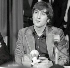 a man sitting at a table with an apple in front of him