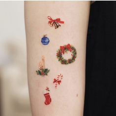 a woman's arm with christmas decorations on it