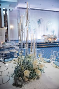 an elegant centerpiece with white flowers and candles