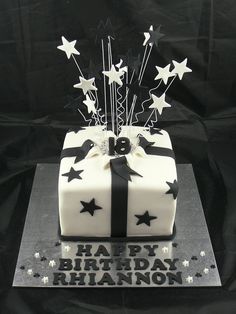 a black and white birthday cake with stars on it