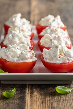 tomatoes stuffed with cream cheese on a plate