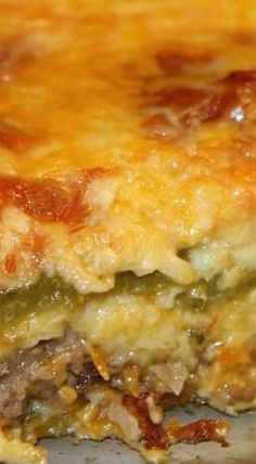 a close up of a casserole with meat and cheese