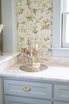 two wine glasses sitting on top of a marble counter