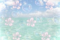 soap bubbles floating in the air over water with hearts and flowers on it's side