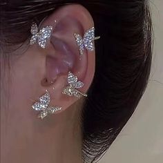 a close up of a person with ear piercings on their ears and behind the ear