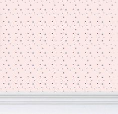 a pink wallpaper with small blue and red dots on it, next to a white frame