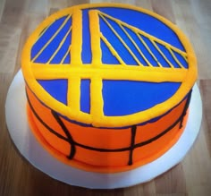 a birthday cake decorated with a basketball and the golden state warriors'logo on it