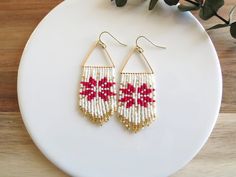 Inspired by the popular fair isle pattern that you see on cozy winter sweaters, these earrings are perfect for all of your holiday parties and events. Approx. size: 2.75 in. long by 1 in. wide. Handmade with love <3 Ear wires are 14K gold plated hypoallergenic. Design credit: pattern acquired by Etsy shop HandMadeInUA **Each of my earrings are delicately handwoven bead by bead. I absolutely love making these and want you to know that each piece is made with patience, love, and care from start to finish! These earrings are made with size 11/0 Delica Japanese Miyuki glass seed beads. I use strong nylon thread to ensure the integrity of each earring.** Snowflake Beaded Earrings, Holiday Beaded Earrings, Christmas Bead Earrings, Beaded Christmas Earrings, Motif Fair Isle, Christmas Tree Beads, Stitch Earrings, Beaded Fringe Earrings, Winter Earrings