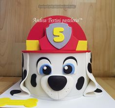 a cake shaped like a fireman's hat with the number 3 on it