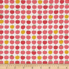 an apple pattern on white fabric with red and yellow apples