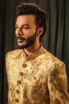 a man with a beard wearing a golden outfit