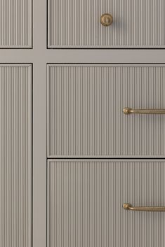 the drawers are painted gray with gold handles