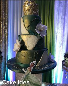 there is a three tiered cake decorated with princess and the frog figurines