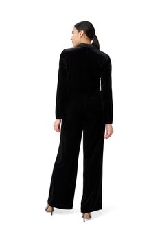 An updated twist on our iconic jumpsuit. A classic menswear-inspired style gets reimagined for todays on-the-go woman. Crafted of an incredible comfortable and soft stretch velvet and features a notched collar, surplice neckline and slight ruching along the bodice for textural interest. We love the flattering wide-leg silhouette. Tuxedo Jumpsuit, Velvet Tuxedo, Jumpsuit Black, Feather Dress, Cold Weather Outfits, Tshirt Skirt, Jumpsuit Trousers, Stretch Velvet, Menswear Inspired