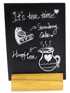 a chalk board with writing on it and some teapots next to it that says it's tea time strawberry cake honey tea