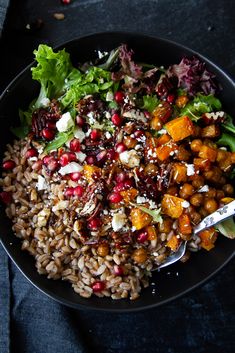 a bowl filled with rice and vegetables on top of a table