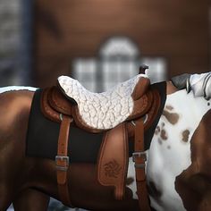 a brown and white horse wearing a saddle