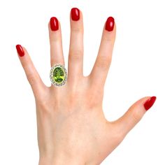 This is a truly beautiful ring, from the size and quality of peridot it features to the exquisite Florentine inspired craftsmanship. The large oval peridot is clear and crystalline, with bright, "Granny Smith" apple green color, set in 18k yellow gold to highlight its beauty. If August is your birth month, peridot is your birthstone. Sparkling round brilliant cut diamonds further adorn the white gold portion of the ring which has been intricately pierced, creating an elegant, regal appearance. H Luxury Peridot Rings With Accent Stones, Luxury Oval Peridot Rings, Formal Green Citrine Jewelry, Elegant Green Citrine Jewelry, Oval Multi-stone Peridot Gemstones, Elegant Multi-stone Peridot Gemstones, Luxury Peridot Multi-stone Jewelry, Luxury Multi-stone Peridot Jewelry, Luxury Peridot Jewelry With Accent Stones