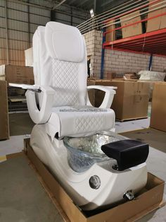 an inflatable chair is sitting on top of a cardboard box and surrounded by boxes