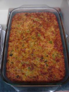 a casserole dish in a glass pan on top of a counter next to aluminum foil