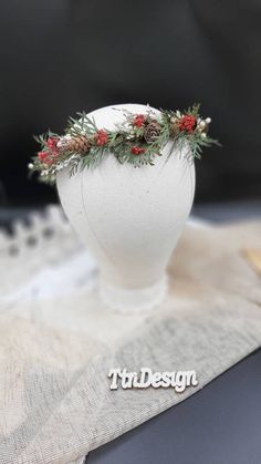 a white vase sitting on top of a table