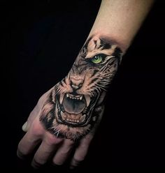 a hand with a tiger's face and green eyes on the left side of it