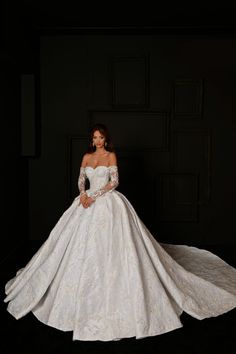 a woman in a white wedding dress posing for the camera with her hands on her hips