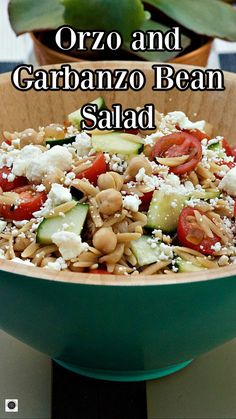 a salad with cucumbers, tomatoes and feta cheese in a green bowl