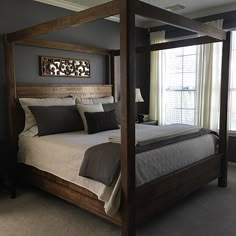 a large bed sitting in a bedroom next to a window