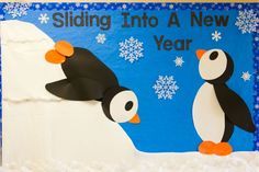 a bulletin board with penguins and snowflakes on it that says sliding into a new year