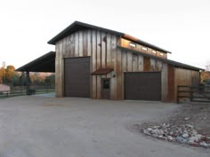 two garages in the middle of a gravel lot