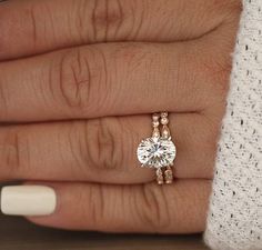 a woman's hand with a diamond ring on it