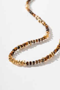 Description Introducing our exquisite handcrafted necklace, adorned with meticulously beaded Tiger's Eye stones and accented with the timeless elegance of 18k gold. Each Tiger's Eye, known for its rich hues and chatoyant brilliance, is carefully hand-beaded to create a stunning composition. The warm golden tones of the 18k gold enhance the natural beauty of the stones, adding a touch of luxury to this unique piece. Material Natural Tiger's eye Stone: a captivating gemstone known for its unique c Luxury Single Strand Round Beaded Necklace, Luxury Hand-strung Beaded Necklace With Round Beads, Luxury Yellow Gold Jewelry With Gold Beads, Luxury Yellow Gold Beaded Jewelry, Gold Heishi Beads Jewelry, Amber Gemstone Beads Rondelle Jewelry, Gold Heishi Beads Necklace Hand-strung, Gold Heishi Beads For Gift, Amber Rondelle Gemstone Beads Jewelry