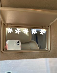 there is a car mirror with flowers on it