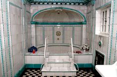 an old fashioned bathroom with black and white checkerboard flooring, green trim