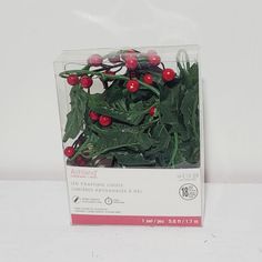 a package of holly leaves with red berries