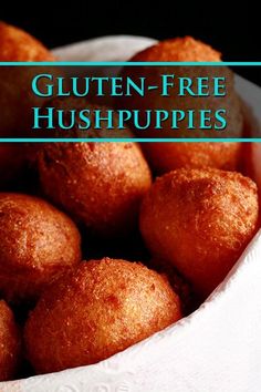 a white bowl filled with gluten - free hush puppies on top of a table