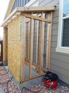 a small shed is being built in front of a house