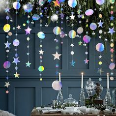 a table topped with lots of stars hanging from the ceiling