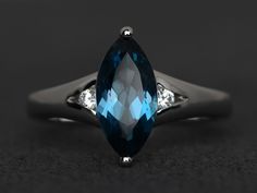 Welcome to my shop, you can find many beautiful gemstone jewelry here, and you also can ask for customized service. Main Stone: London blue topaz, marquise cut, measures 6X12mm, Accent Stones: cz Metal: 925 sterling silver plated with rhodium. I also can provide metal options such as 14k solid yellow/white/rose gold Setting: prong setting More rings please go to my shop home: https://www.etsy.com/shop/XCjewelryStudio?ref=hdr_shop_menu It's a perfect gift for the person who was born in November ( Fine Jewelry Marquise Topaz Ring With Center Stone, Elegant Blue Marquise Cut Topaz Ring, Anniversary Marquise Topaz Ring With Accent Stones, Anniversary Marquise Cut Topaz Ring With Center Stone, Silver Marquise Three-stone Ring, Blue Topaz Ring With Marquise Cut And Accent Stones, Marquise Topaz Promise Ring In Fine Jewelry Style, Marquise Topaz Ring For Promise Occasion, Marquise Topaz Promise Ring