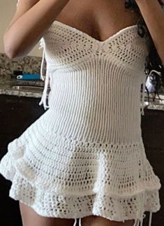 a woman is taking a selfie in the mirror wearing a white crochet dress