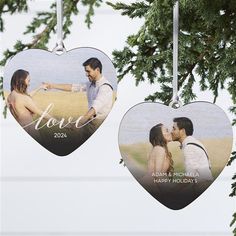 two heart shaped ornament hanging from a tree