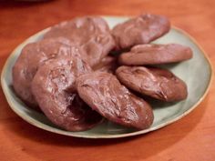 chocolate cookies on a plate sitting on a table