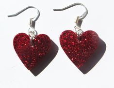 Cute mini red glitter heart earrings. Red glitter starry sparkle hearts on silver fishook earrings posts. Red Glitter Earrings For Party, Red Glitter Party Earrings, Heart-shaped Glitter Earrings For Gifts, Glitter Heart Earrings As Gift, Heart Shaped Glitter Earrings For Gift, Silver Glitter Jewelry For Valentine's Day, Valentine's Day Silver Glitter Jewelry, Glitter Red Earrings For Gifts, Red Glitter Earrings For Gift